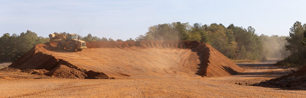 Large vehicle moving sand and gravel